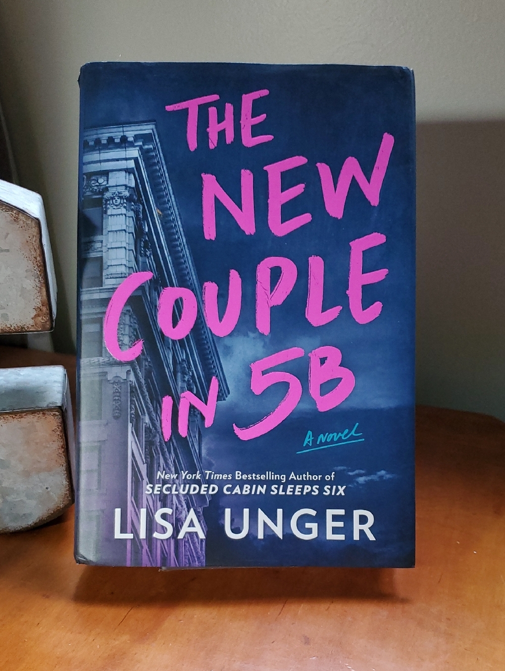 The New Couple in 5B by Lisa Unger - Deep Blue & Hot Pink Hardcover